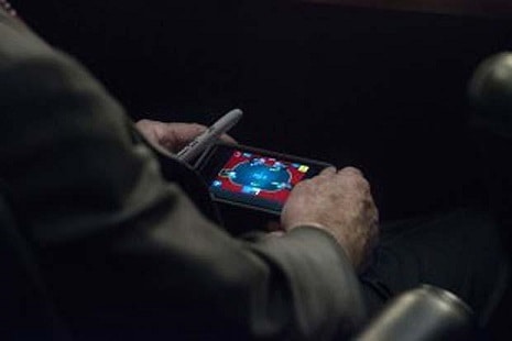 Senator John McCain pictured enjoying a game of mobile poker!